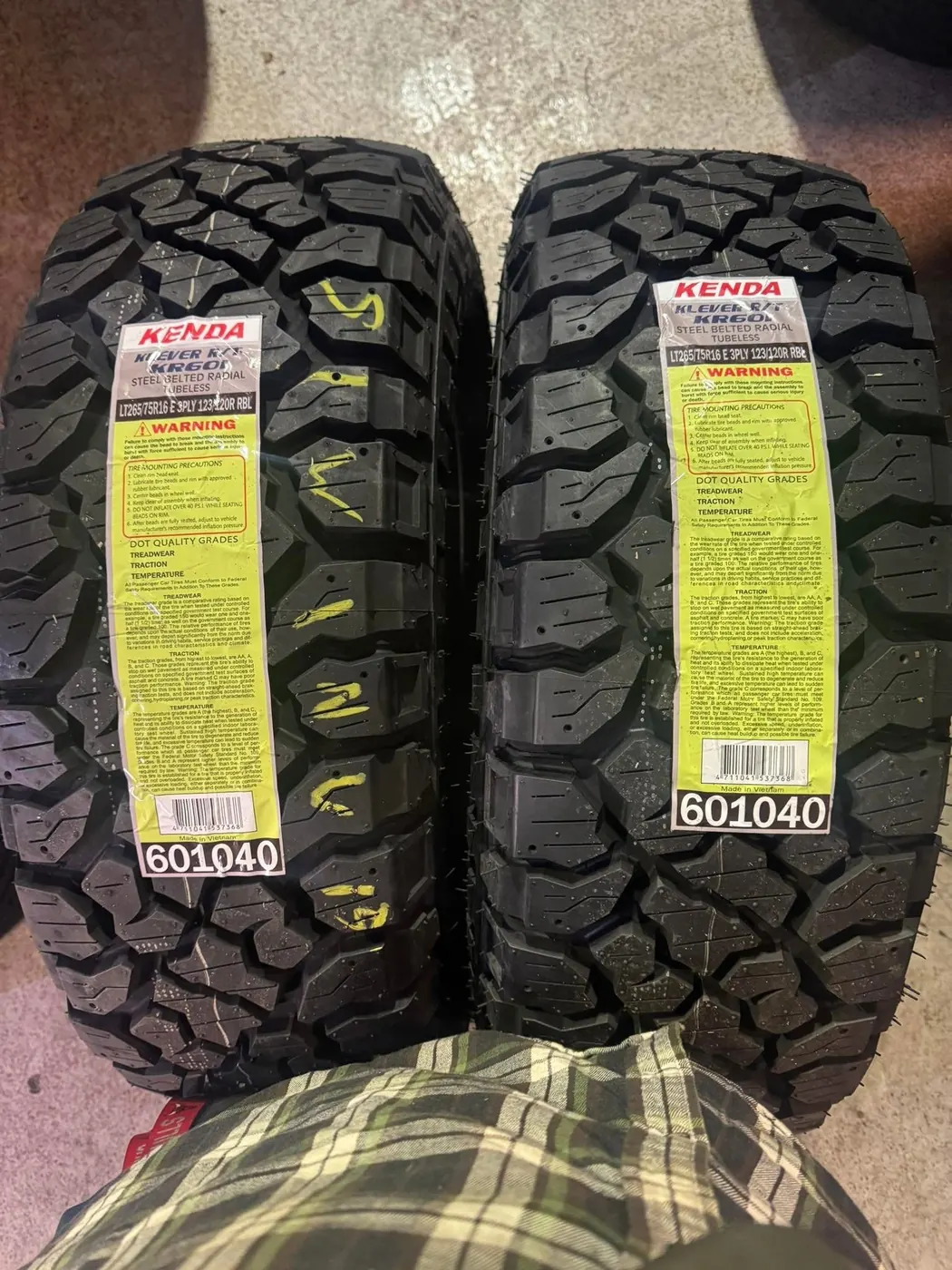 Two new tires with tread and label detail