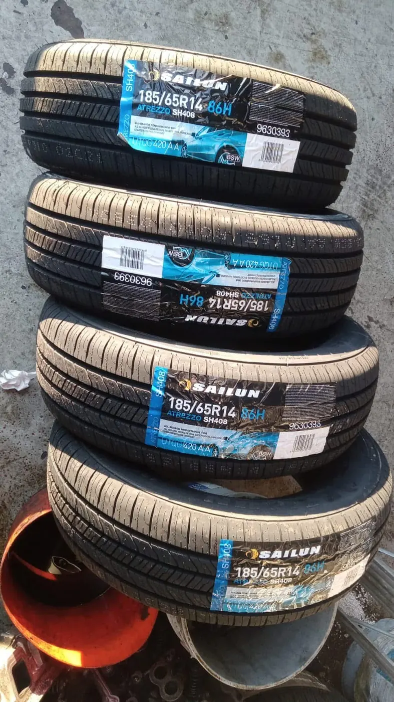 New tires with labels stacked in the shop