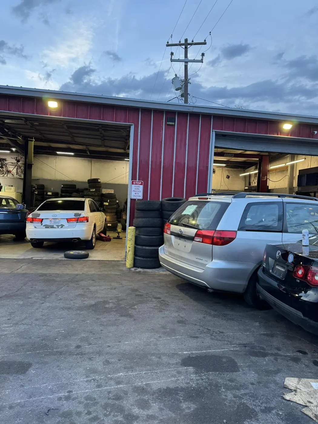Open service bays with customer vehicles parked outside